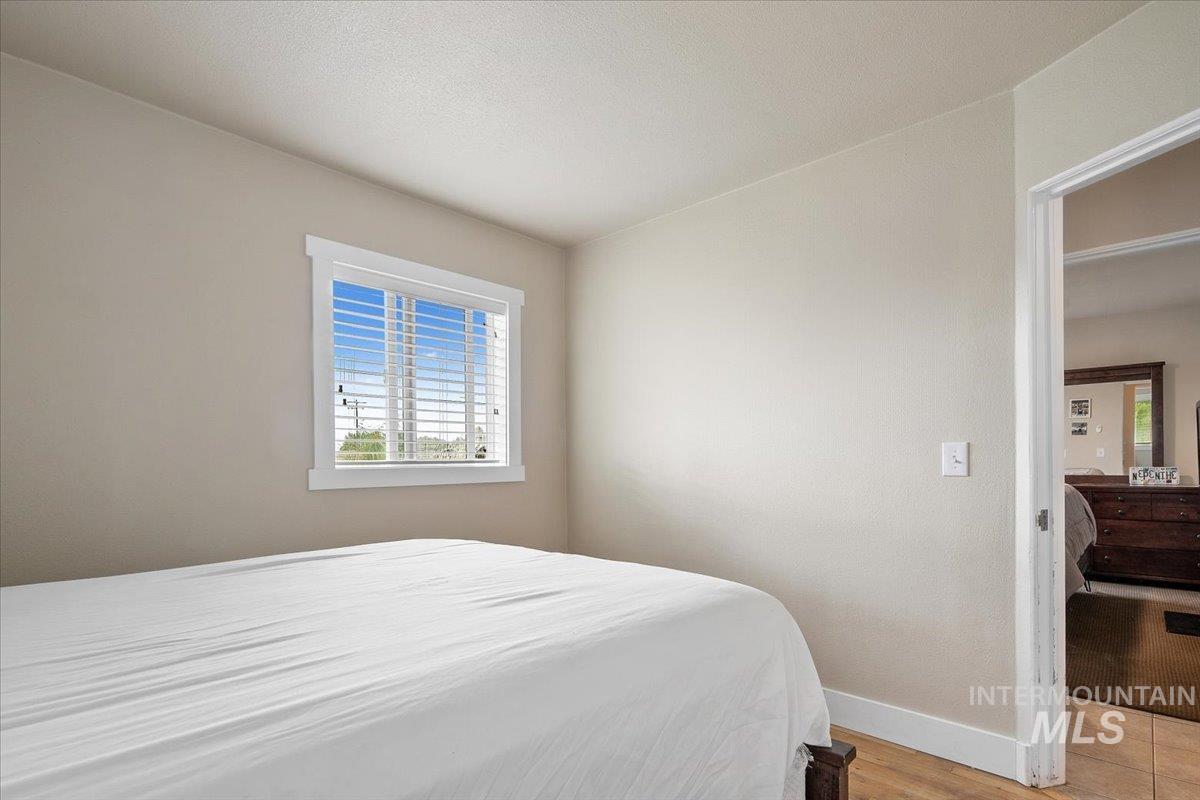 Bedroom featuring baseboards and light wood-type flooring