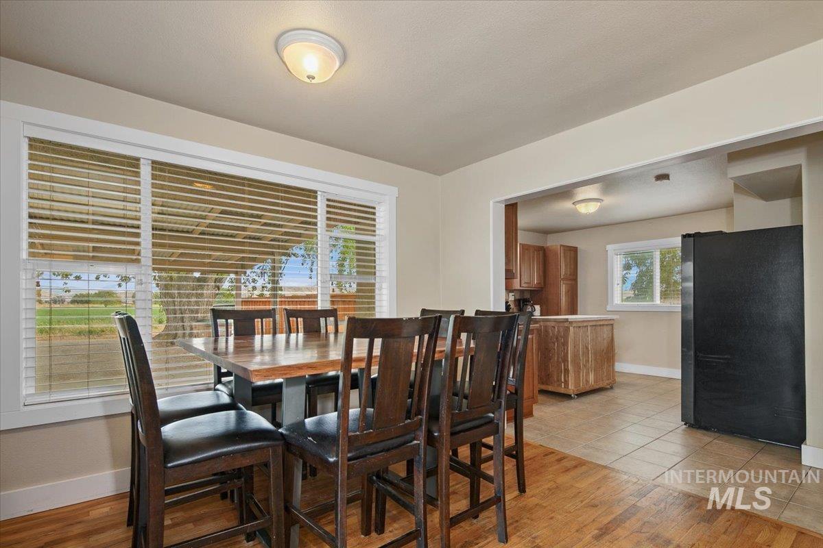Dining room with baseboards and light wood-style flooring