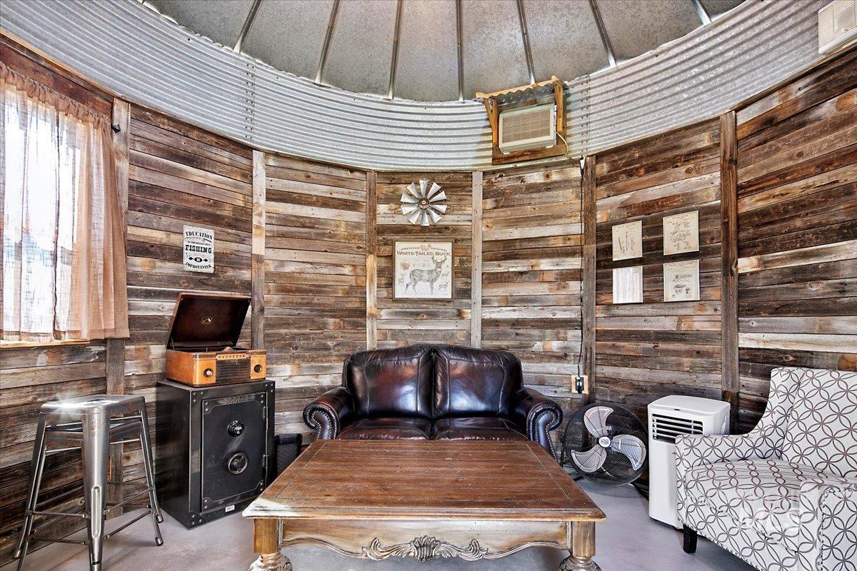 Office space with concrete floors and wood walls