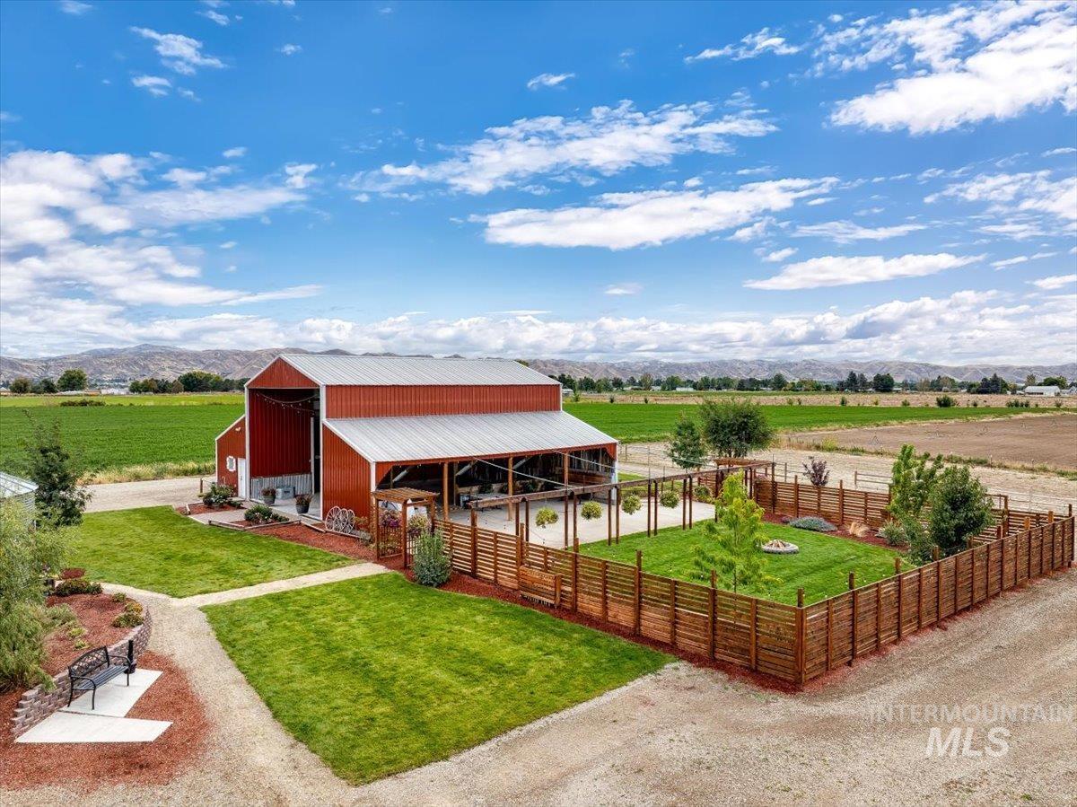 Stable featuring a view of rural / pastoral area, a mountain view, and agricultural area