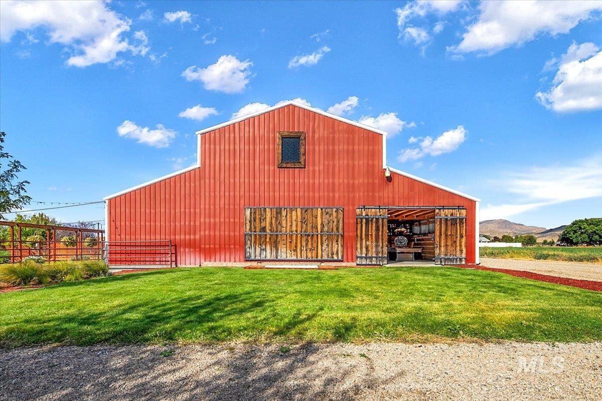 Back of house with an outdoor structure, a pole building, and a mountain view
