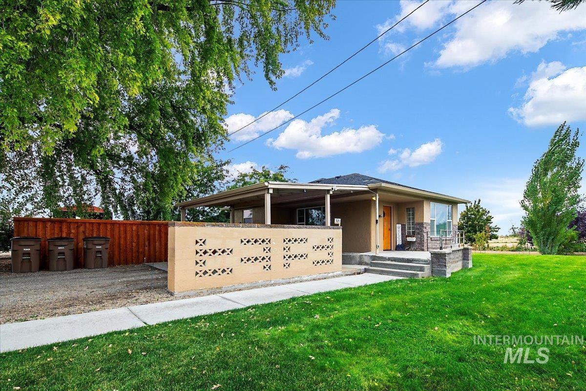 View of front of house featuring a front lawn and a porch
