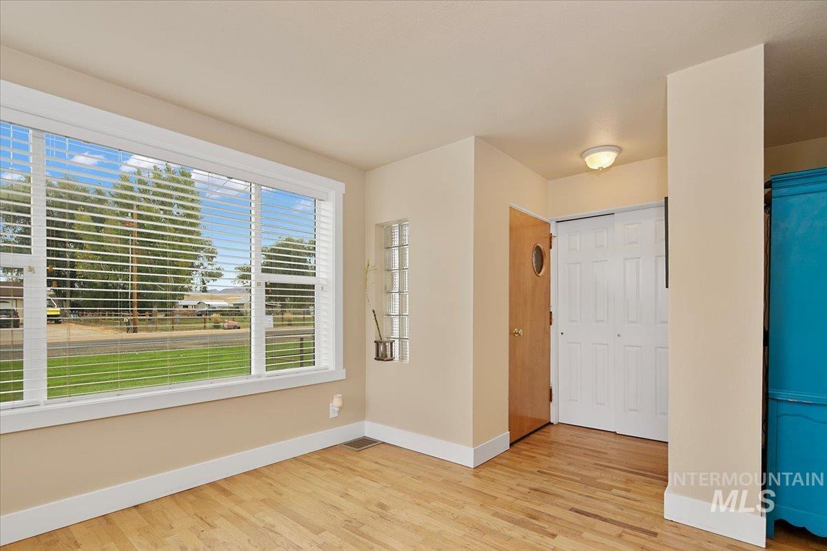Spare room with baseboards and light wood finished floors