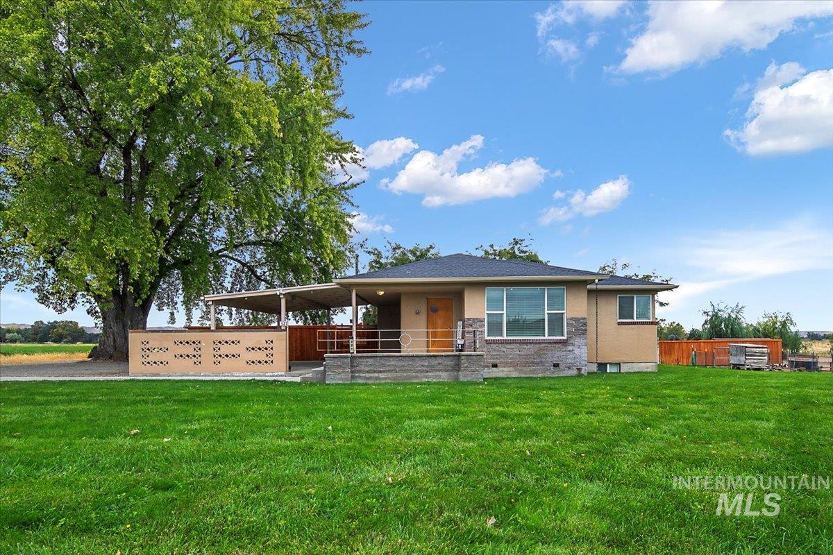 View of front of house with a front lawn and stucco siding