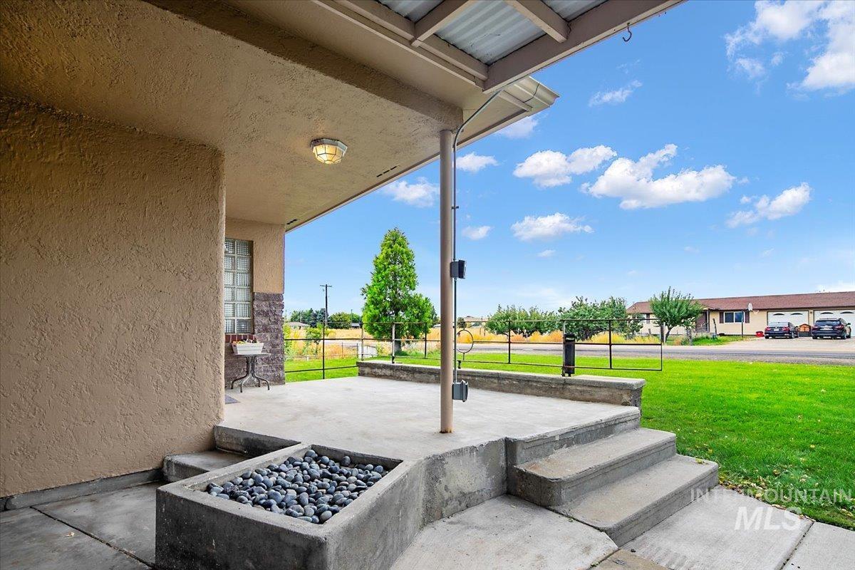 Covered porch featuring a yard