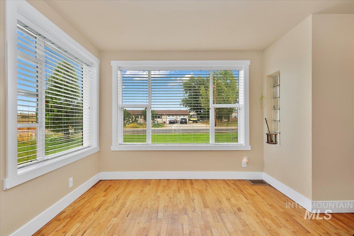 Spare room with light wood-style floors and baseboards
