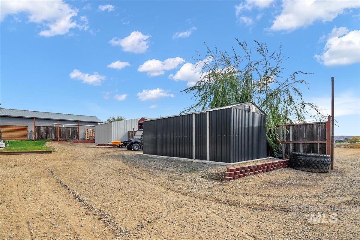 View of yard with an outdoor structure and an outbuilding