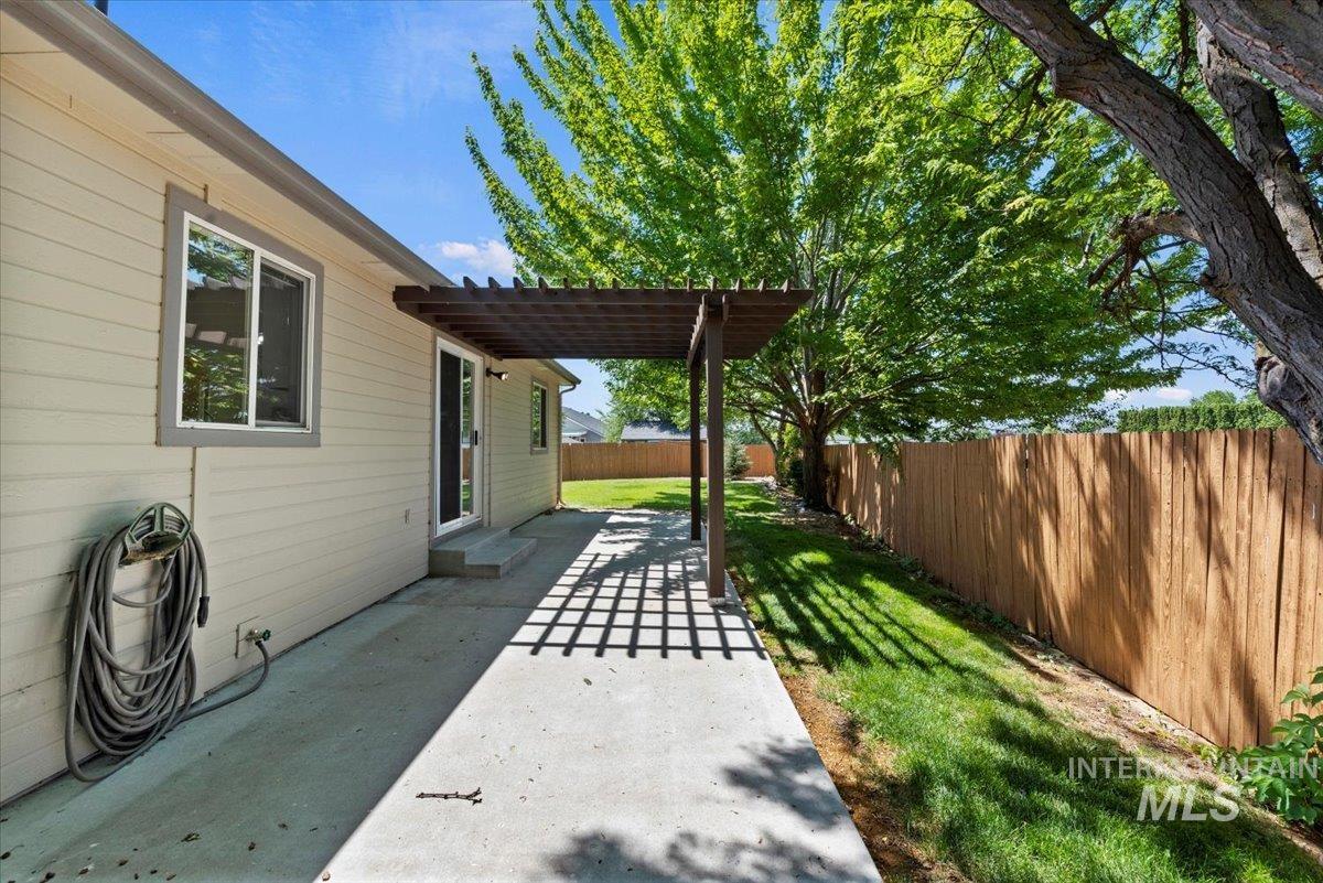 Fenced backyard featuring a patio area and a pergola