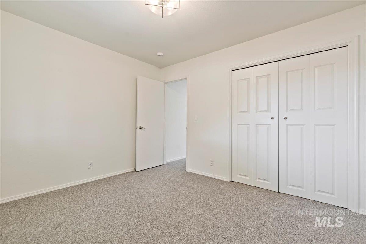 Unfurnished bedroom with carpet flooring and a closet