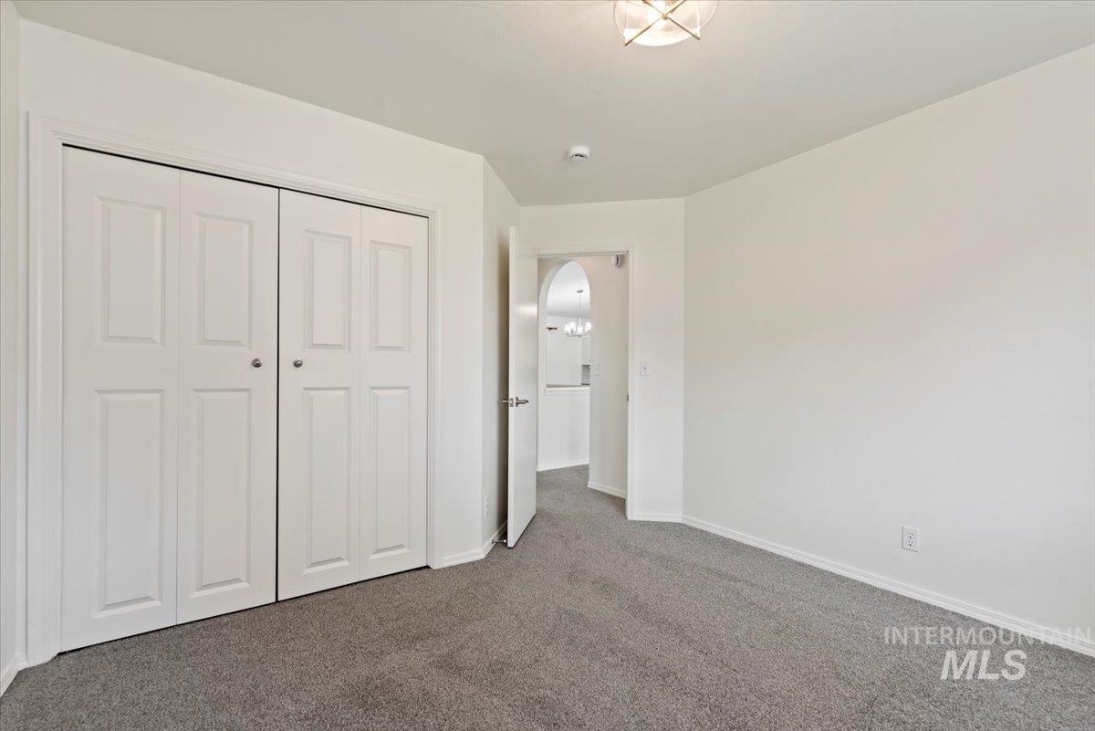Unfurnished bedroom with carpet and a closet