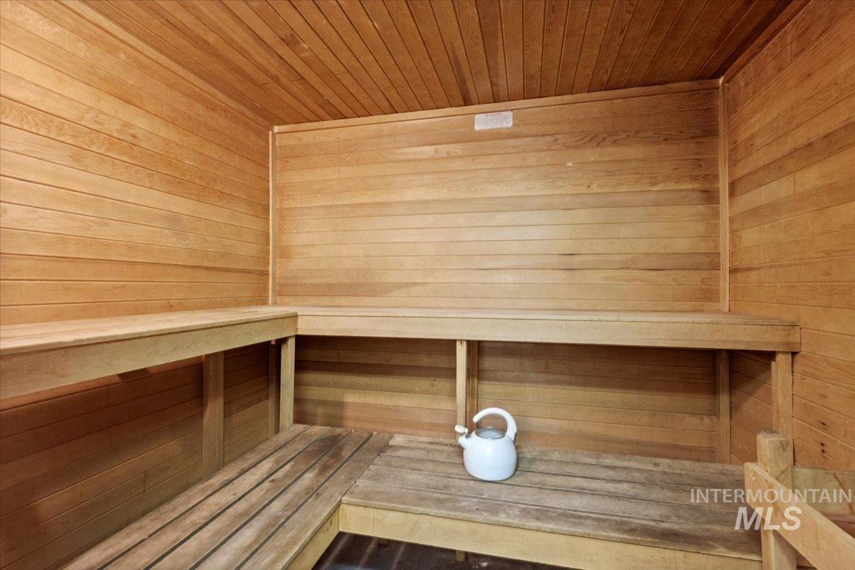 Sauna / steam room featuring wood ceiling and wooden walls