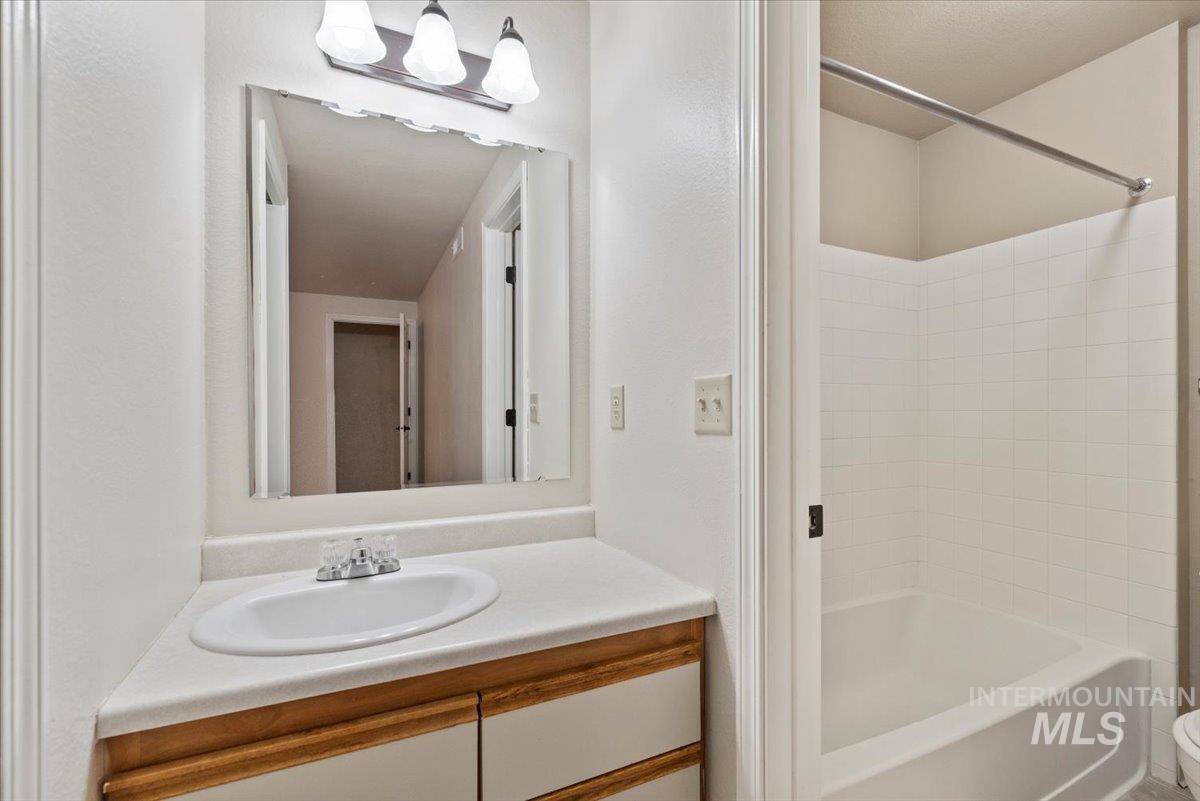 Full bath featuring vanity and shower / bathtub combination