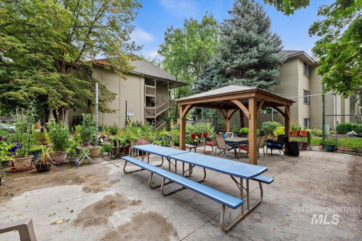 Surrounding community featuring a gazebo, a patio area, and outdoor dining space