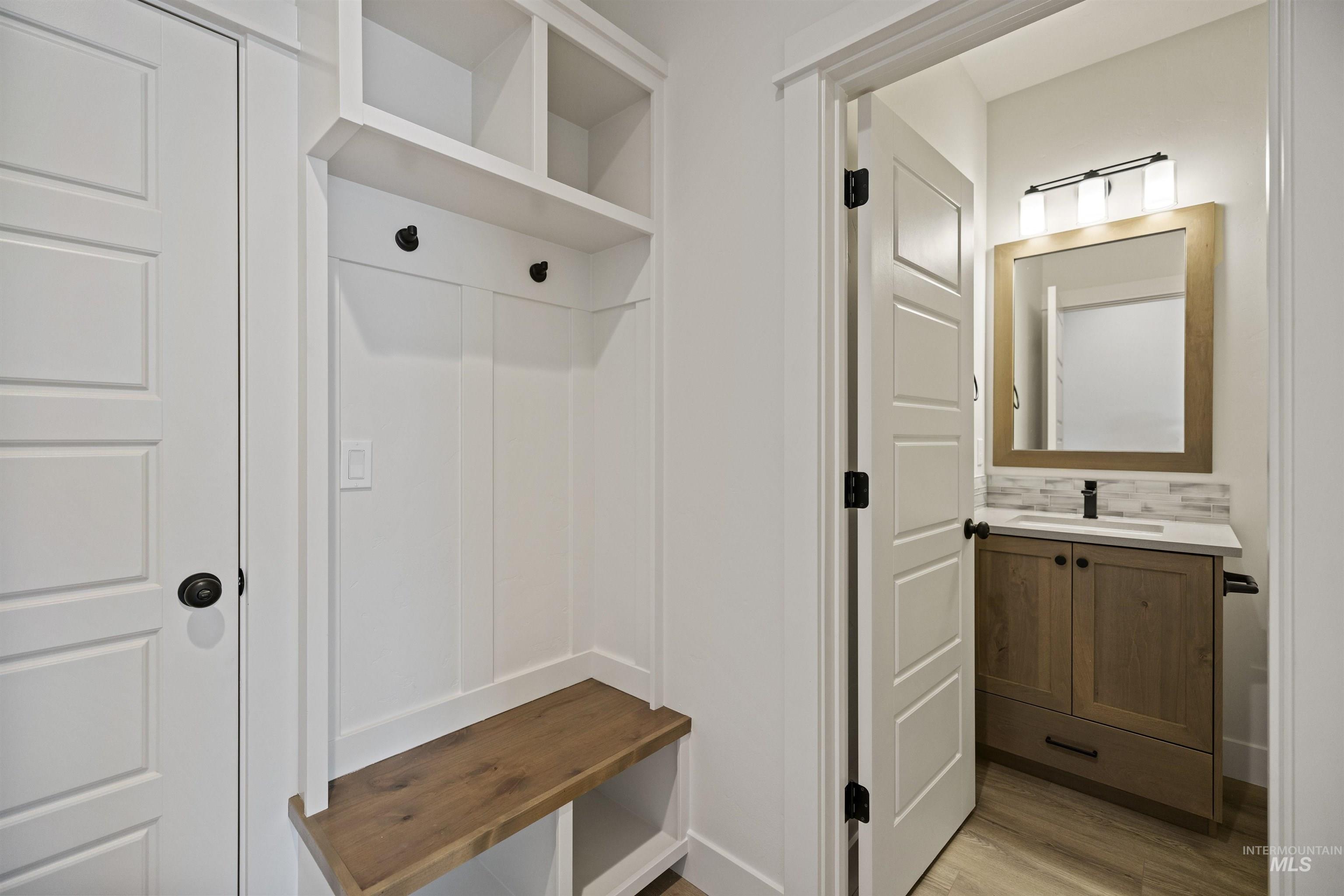 Mudroom with light wood-style flooring and a sink
