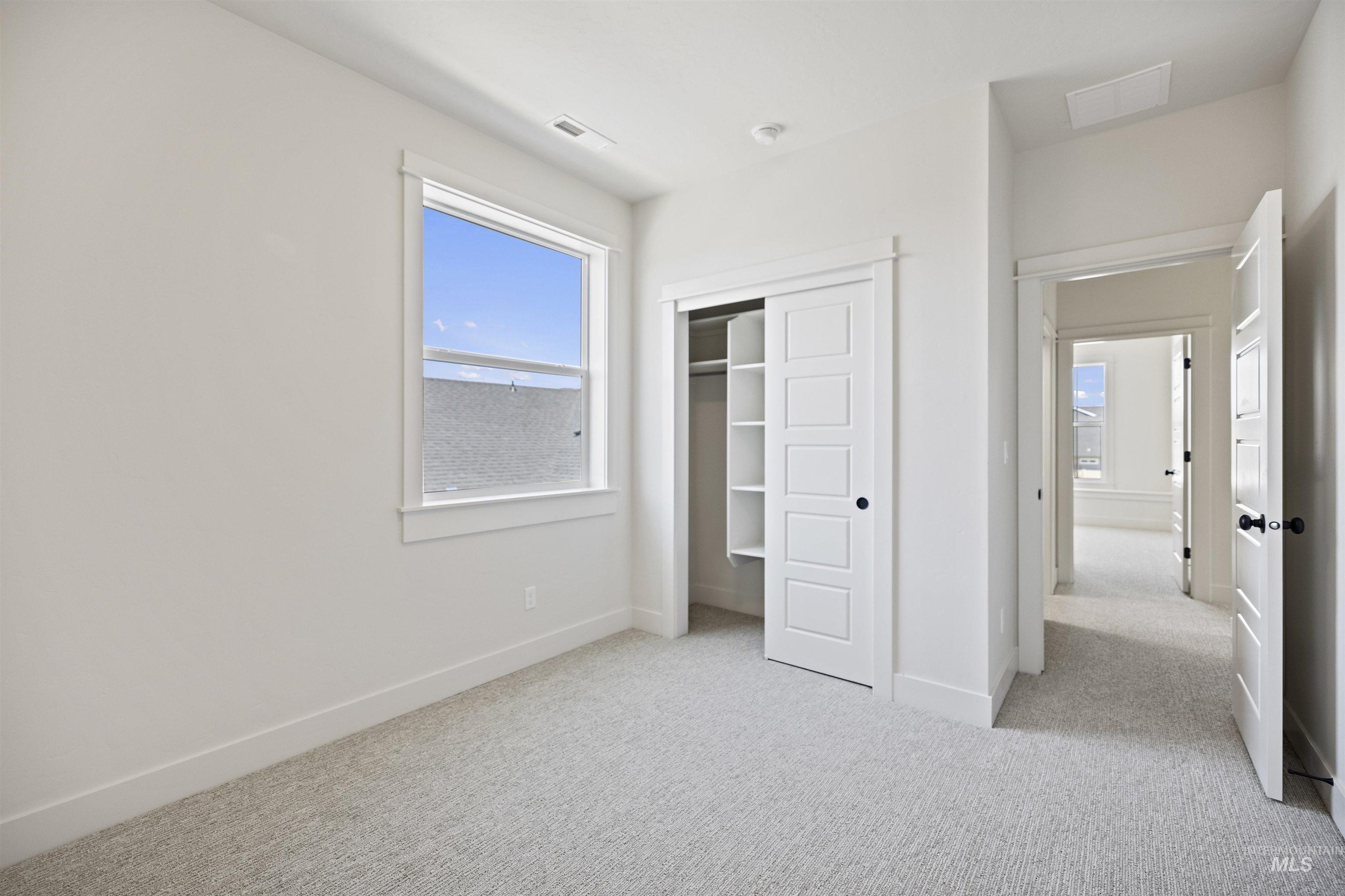 Unfurnished bedroom featuring carpet floors and a closet