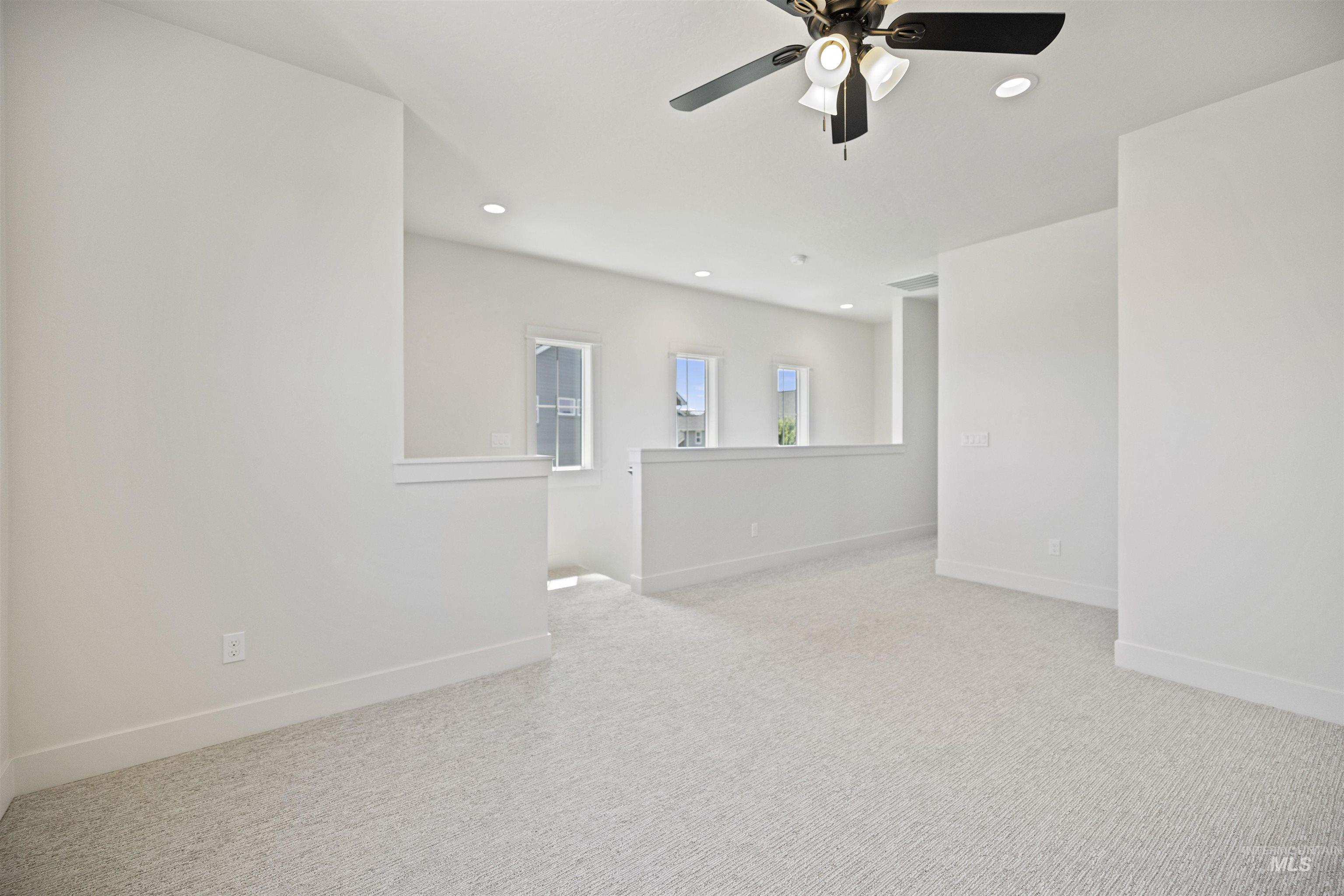 Empty room with ceiling fan, recessed lighting, and carpet floors