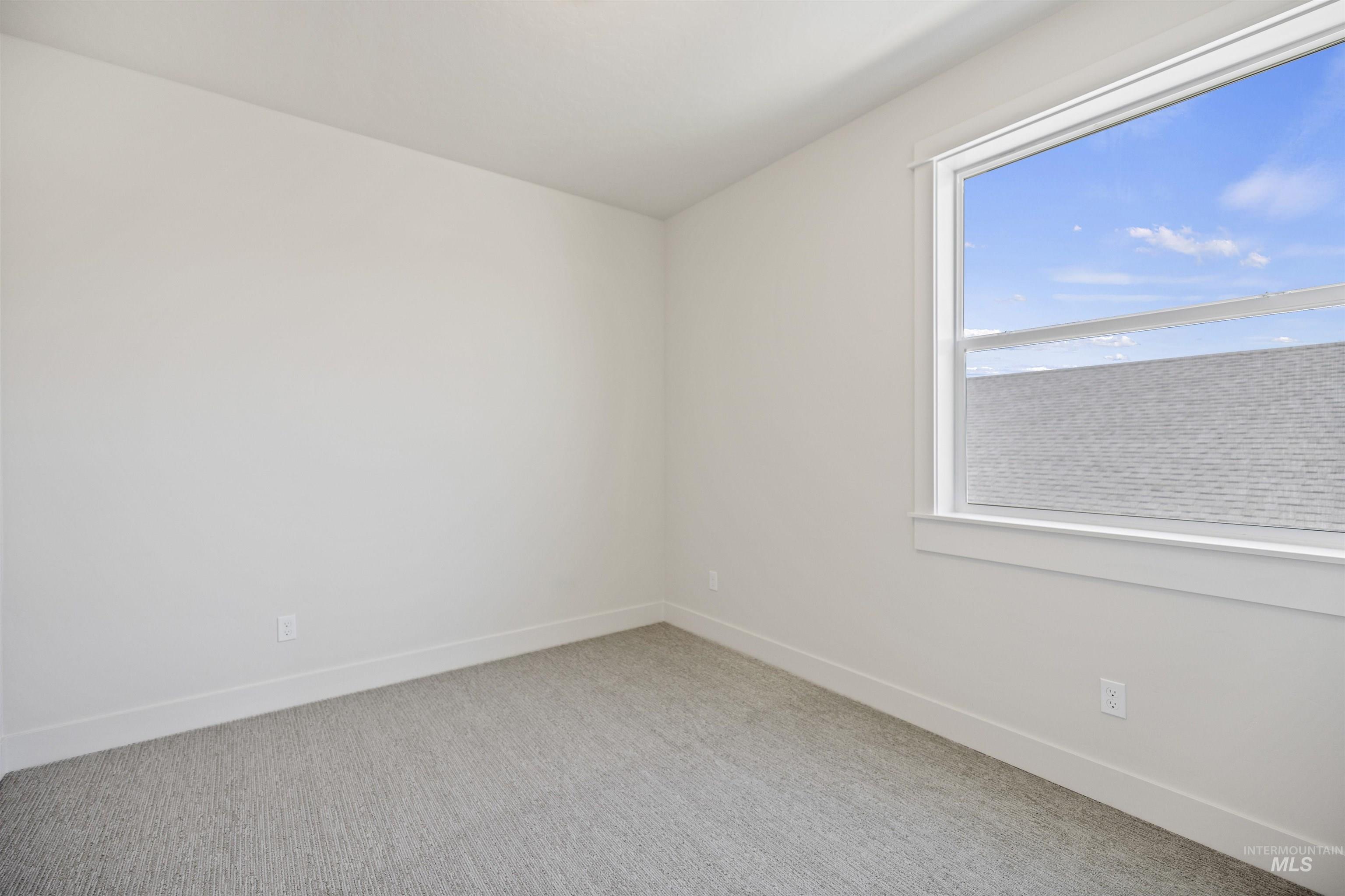 Unfurnished room with carpet floors and baseboards