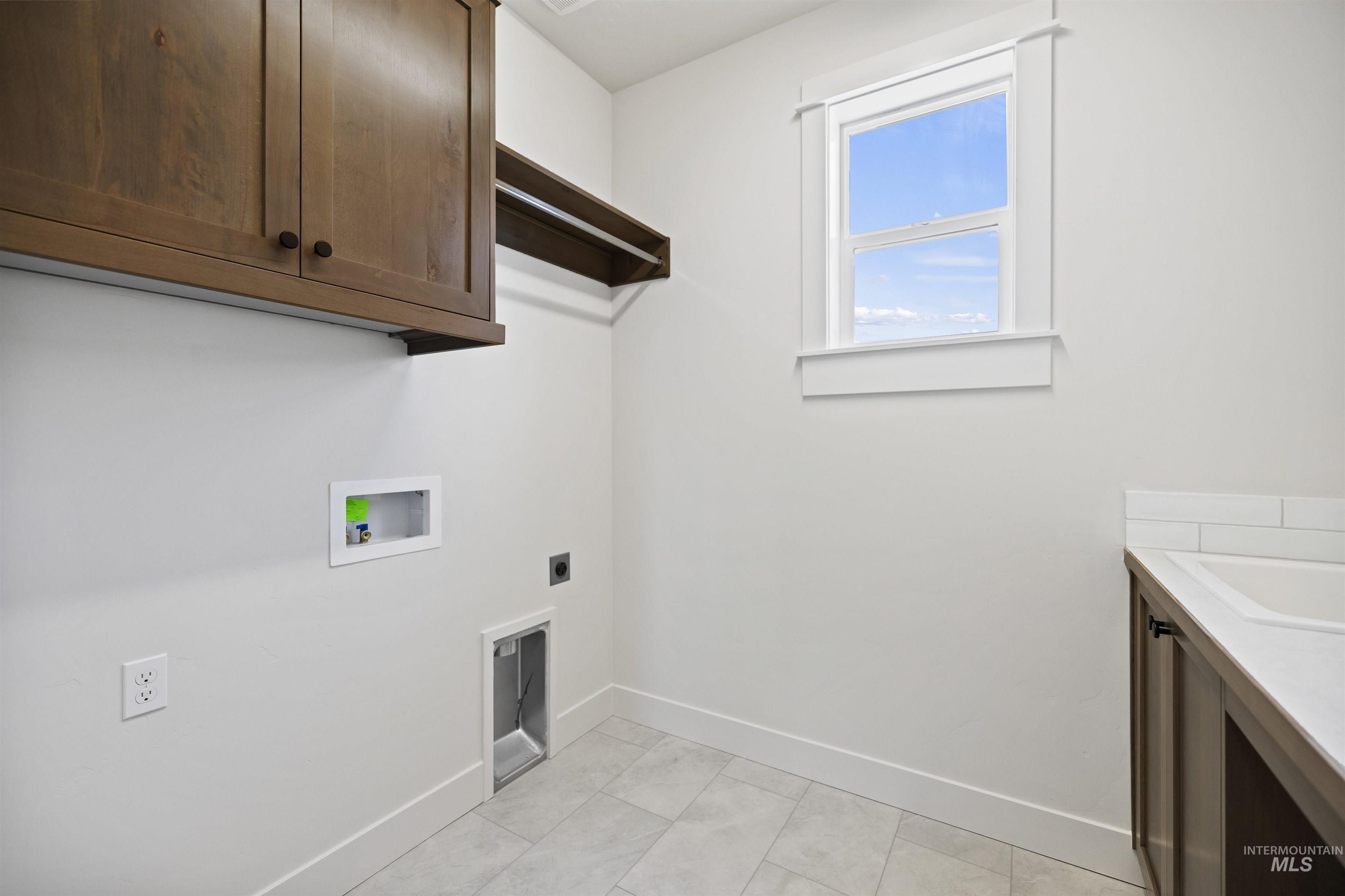 Laundry room featuring cabinet space, washer hookup, and electric dryer hookup