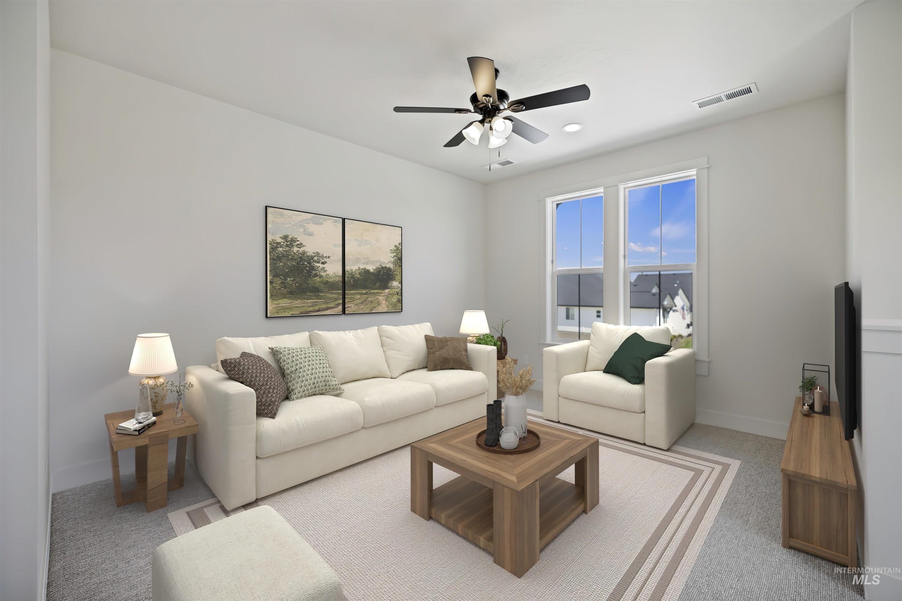 Living area featuring a ceiling fan and carpet