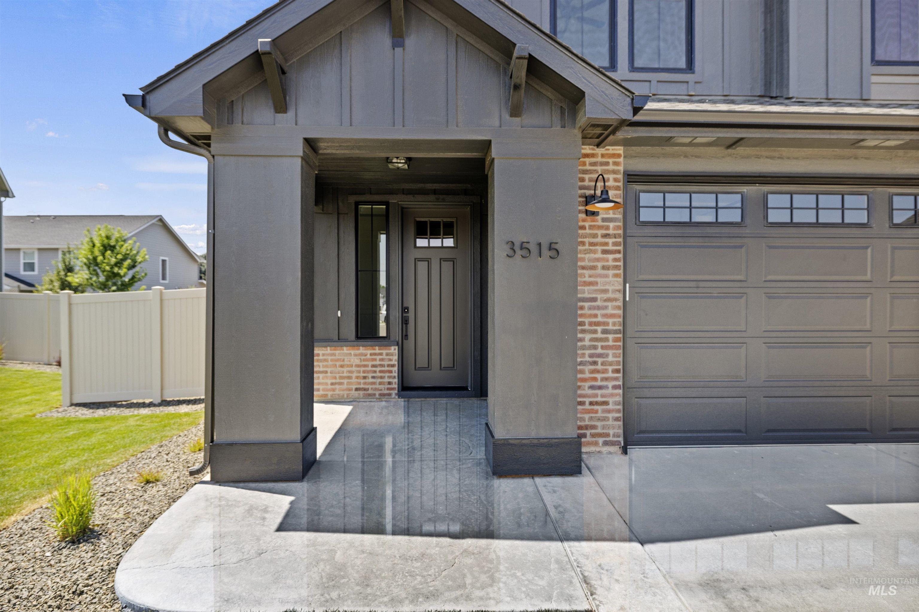 Property entrance featuring brick siding and board and batten siding