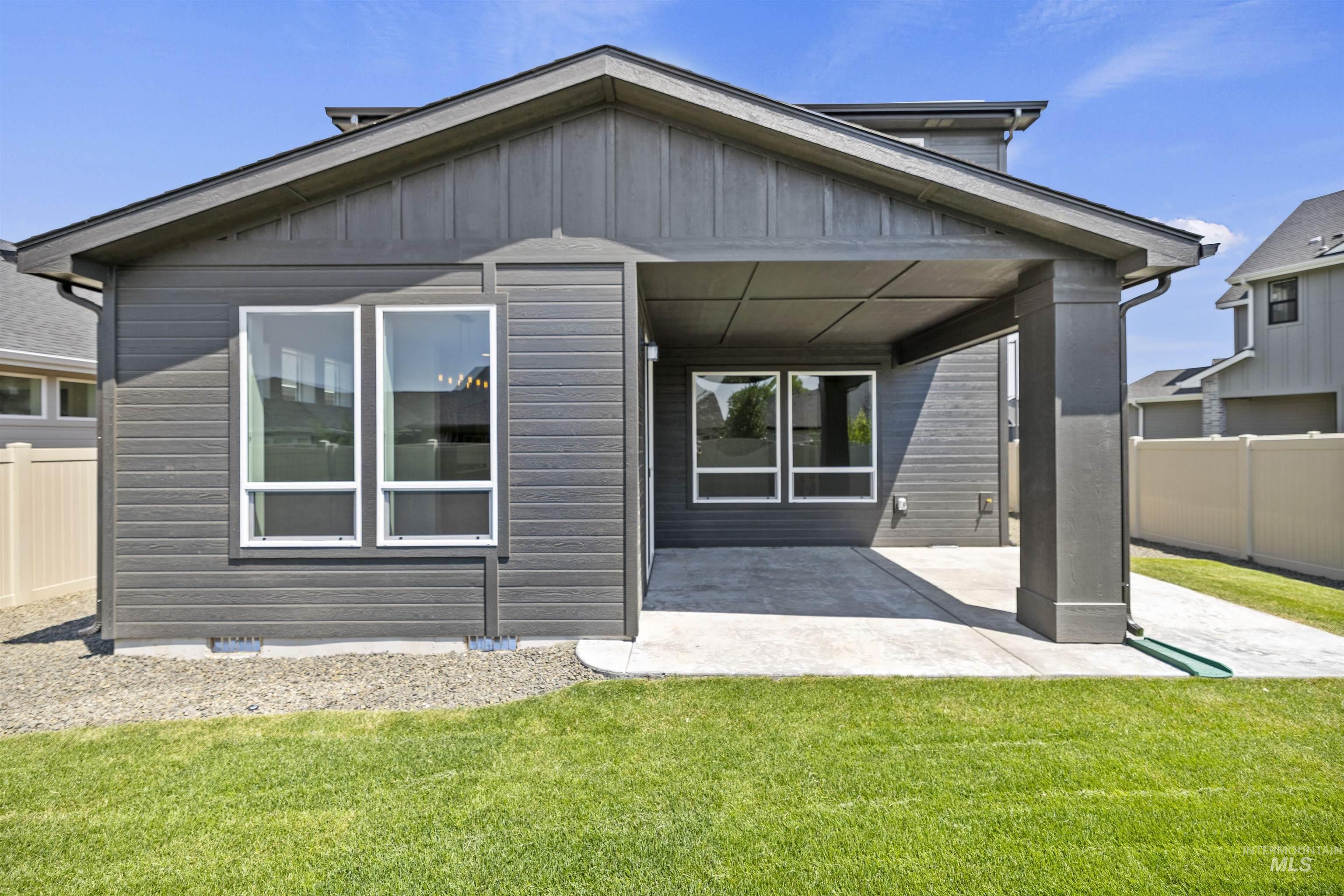 Back of property featuring a patio area and board and batten siding