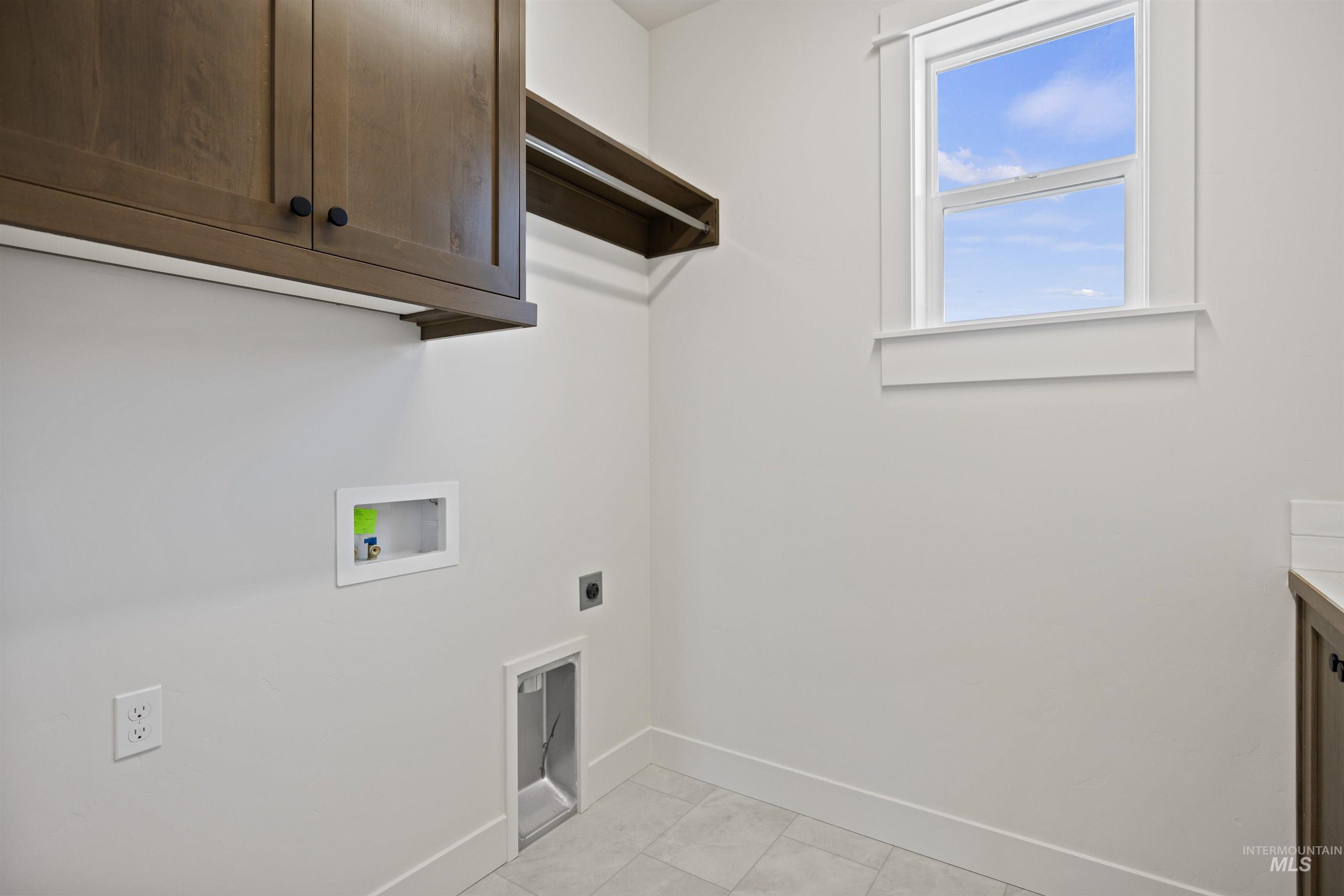 Laundry area featuring cabinet space, electric dryer hookup, and hookup for a washing machine
