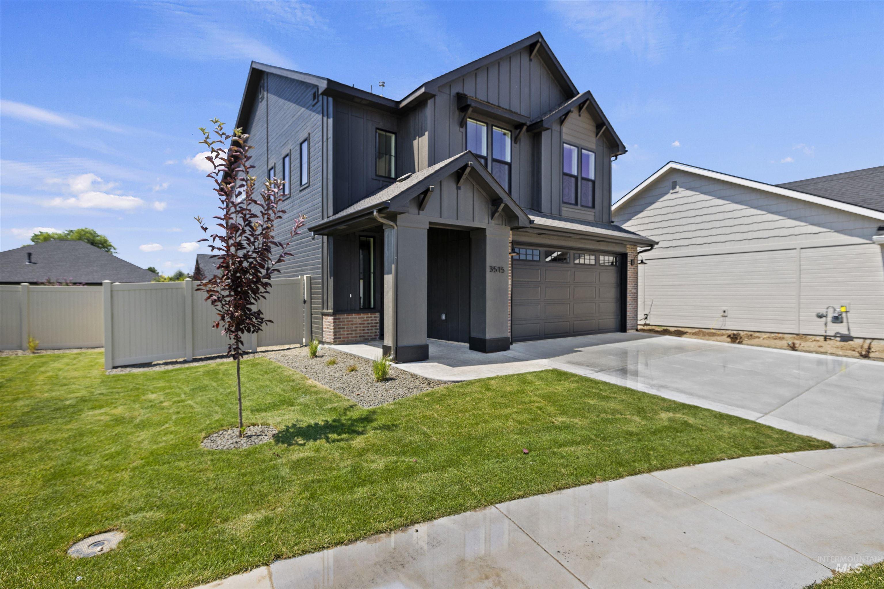 View of front of house featuring driveway, board and batten siding, and a garage