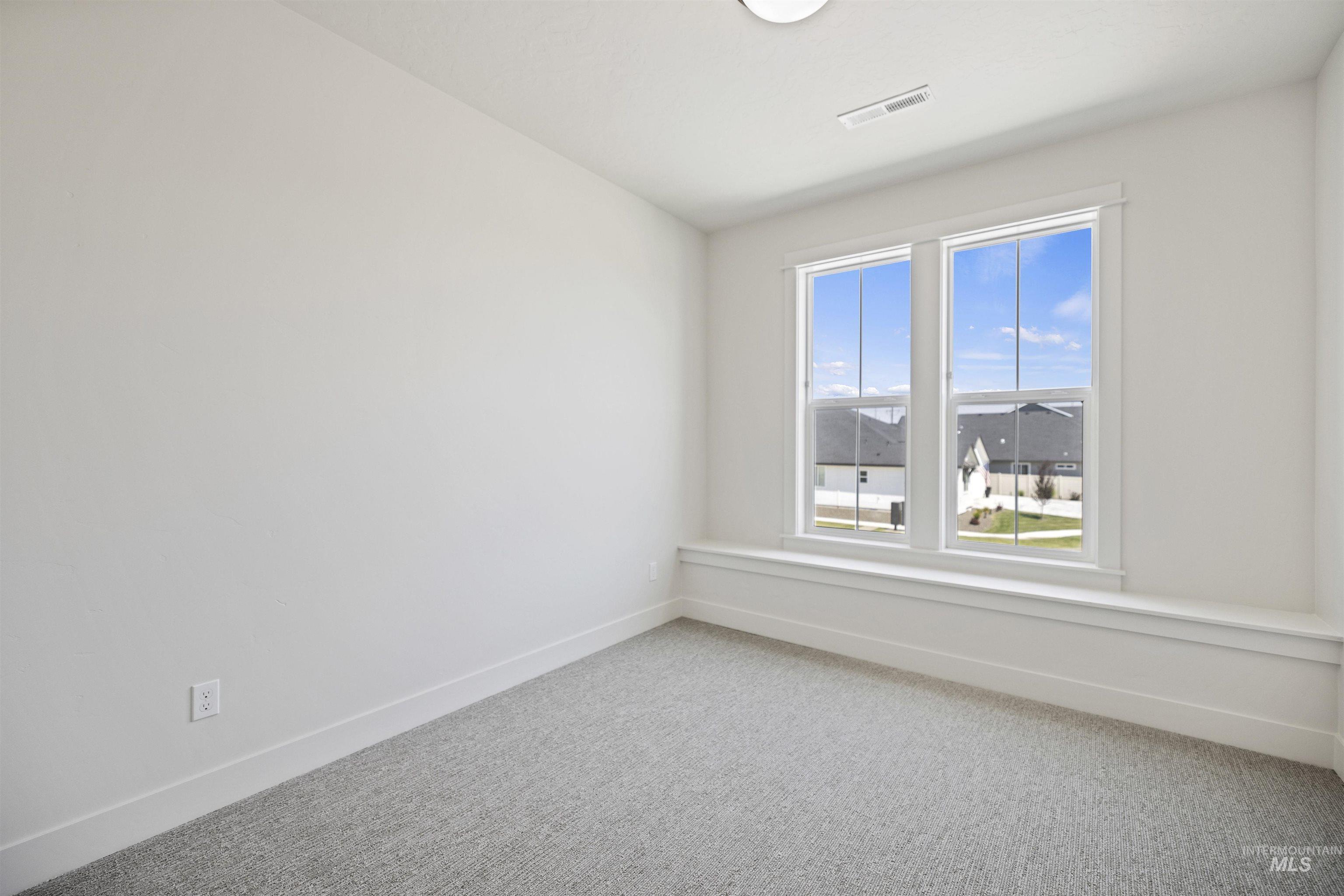 Unfurnished room with light colored carpet