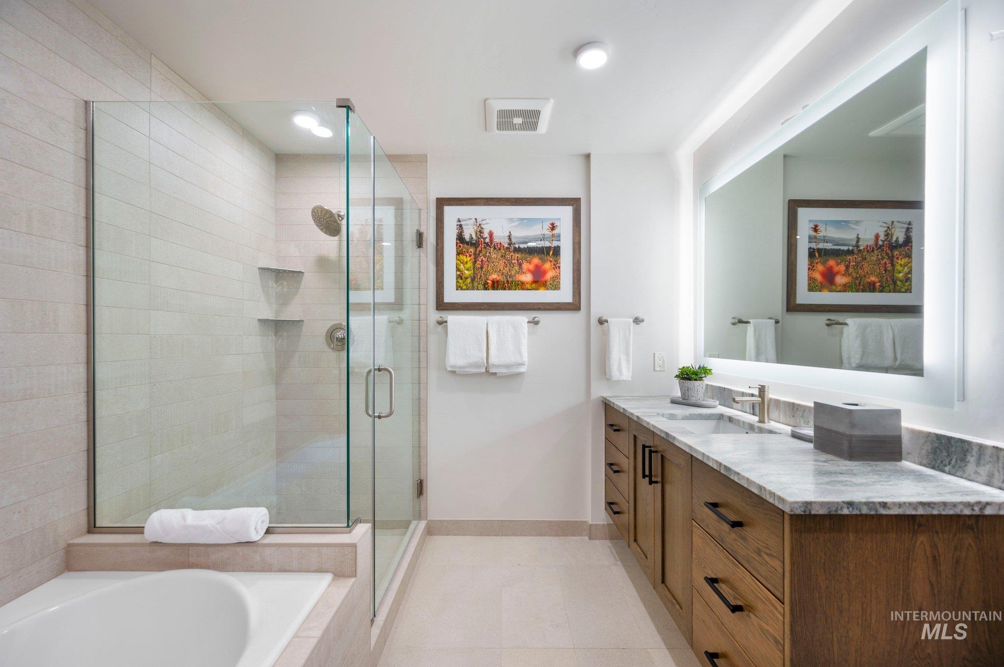 Bathroom with vanity, a stall shower, a bath, light tile patterned floors, and recessed lighting