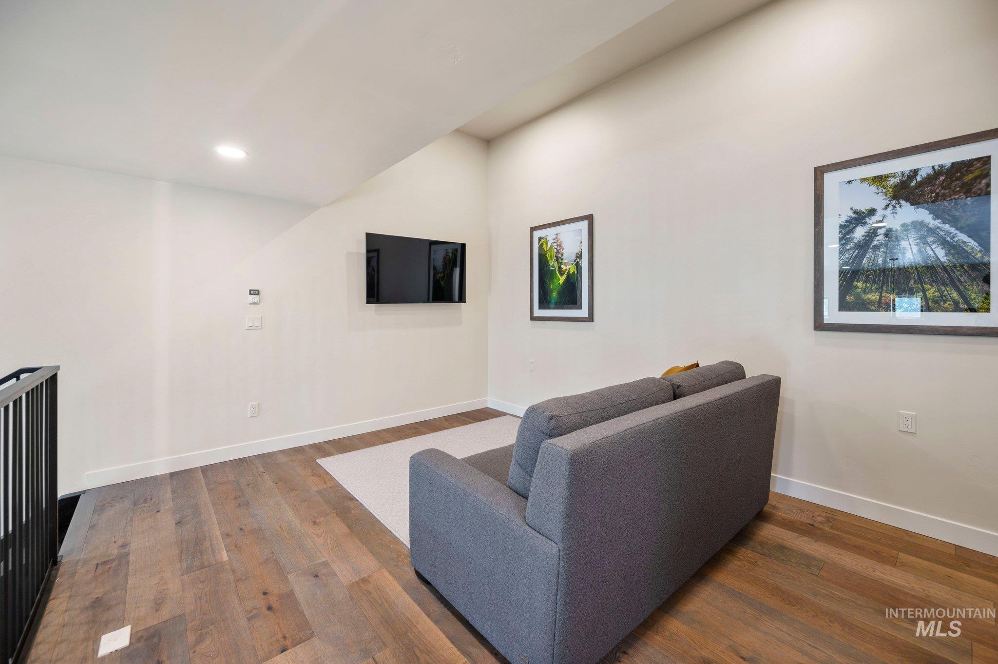 Living area featuring hardwood / wood-style flooring and recessed lighting