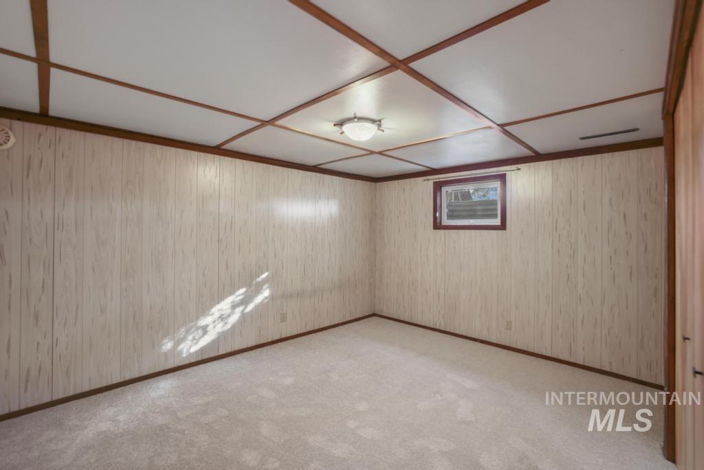 Basement featuring light colored carpet