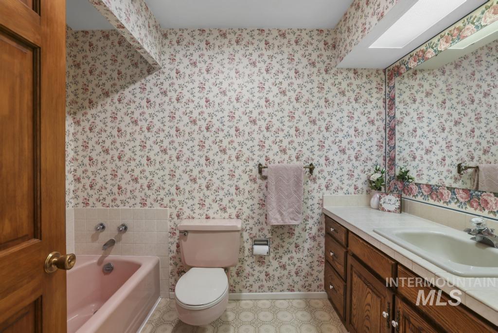 Bathroom featuring a garden tub and vanity