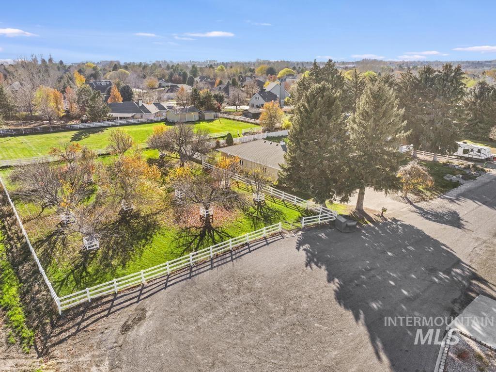 Overview of rural landscape featuring a tree filled landscape and nearby suburban area