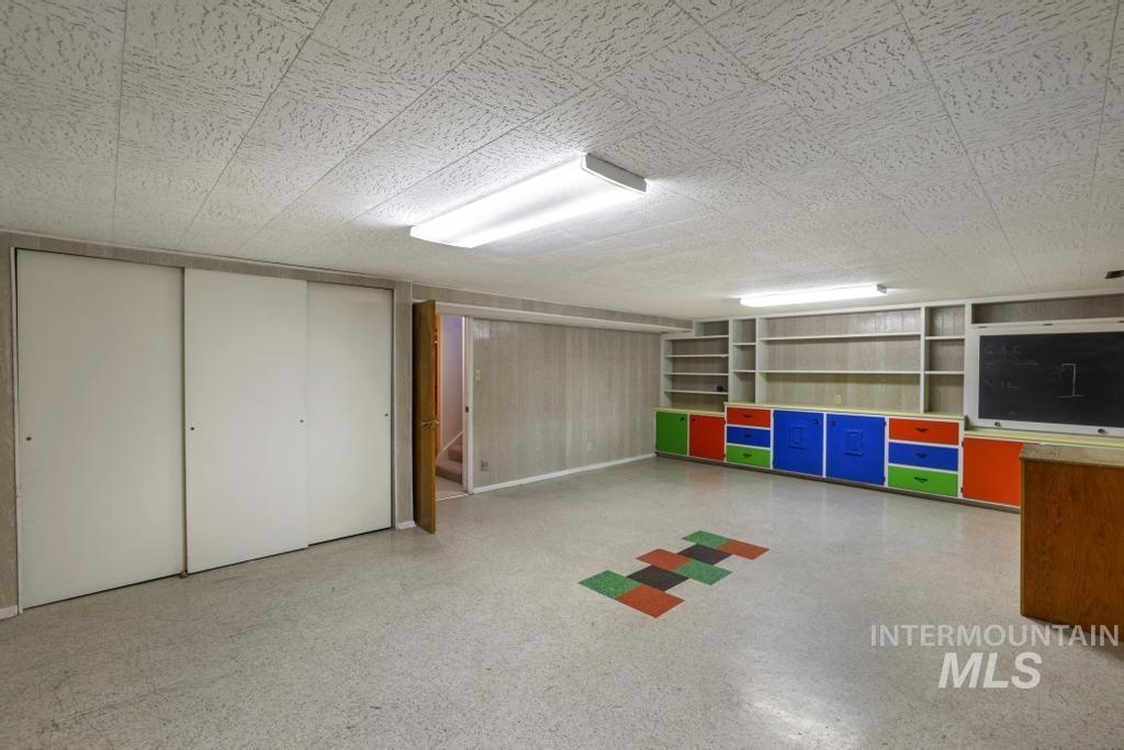 Playroom featuring dark aggregate flooring