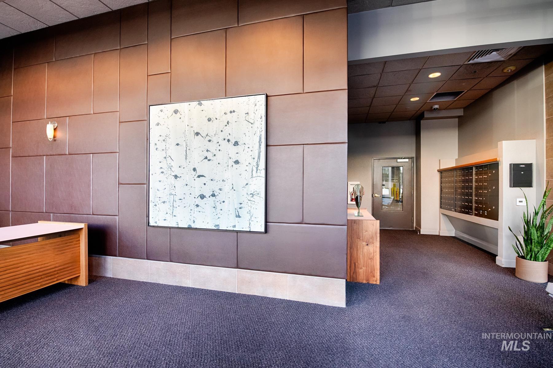 View of community with a drop ceiling and mail area