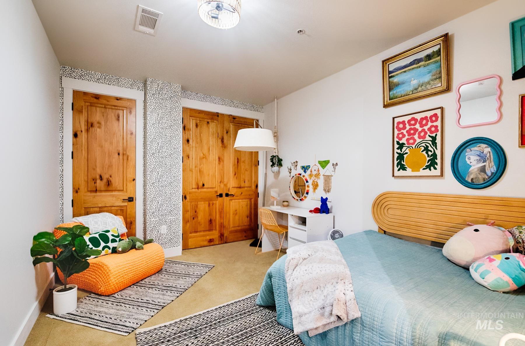 Carpeted bedroom with a closet