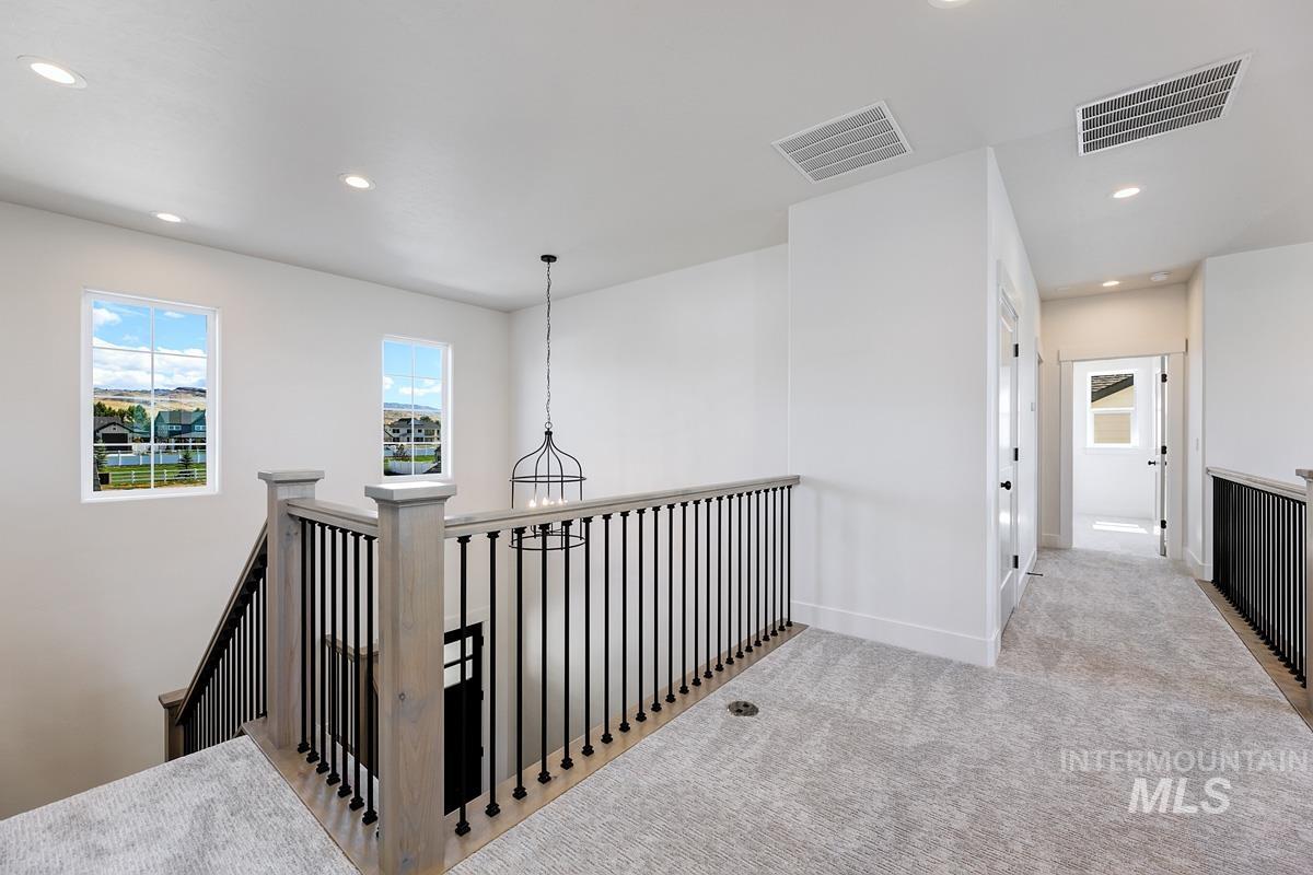 Hall featuring an upstairs landing, recessed lighting, and carpet flooring