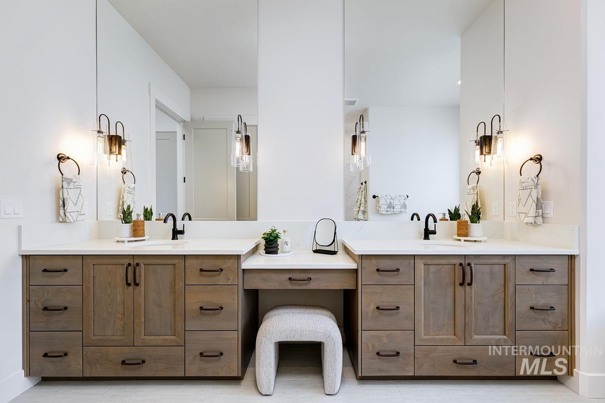 Bathroom with two vanities and light tile patterned flooring