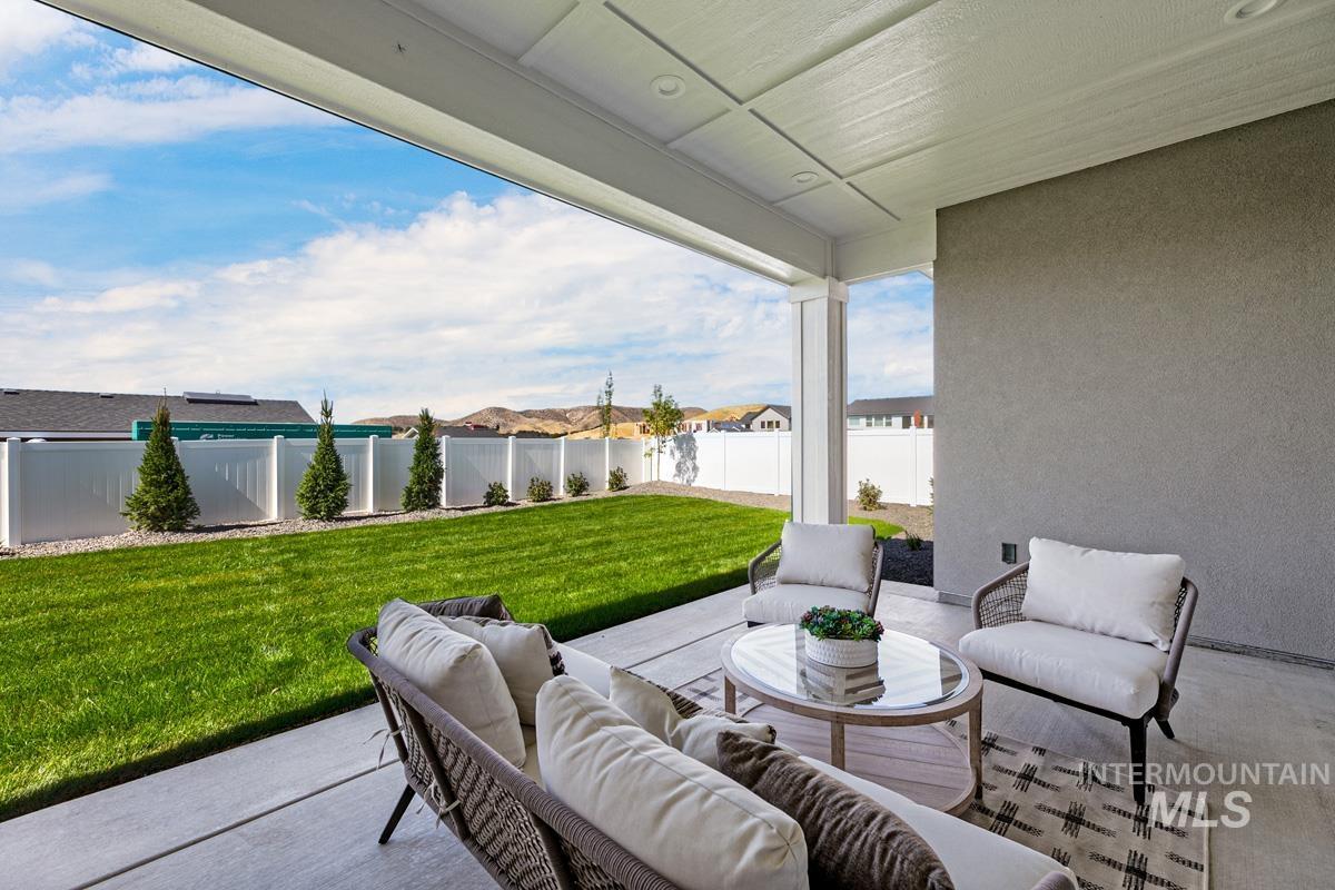 Fenced backyard with outdoor furniture and a patio