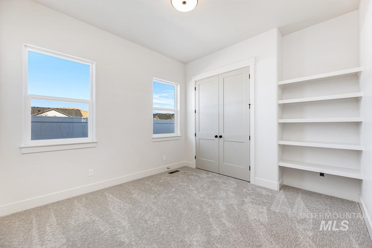 Unfurnished bedroom featuring a closet and carpet floors
