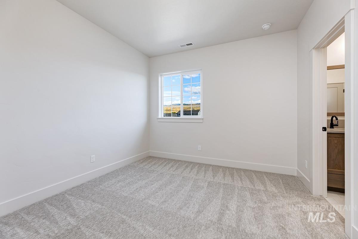 Empty room with light carpet and baseboards