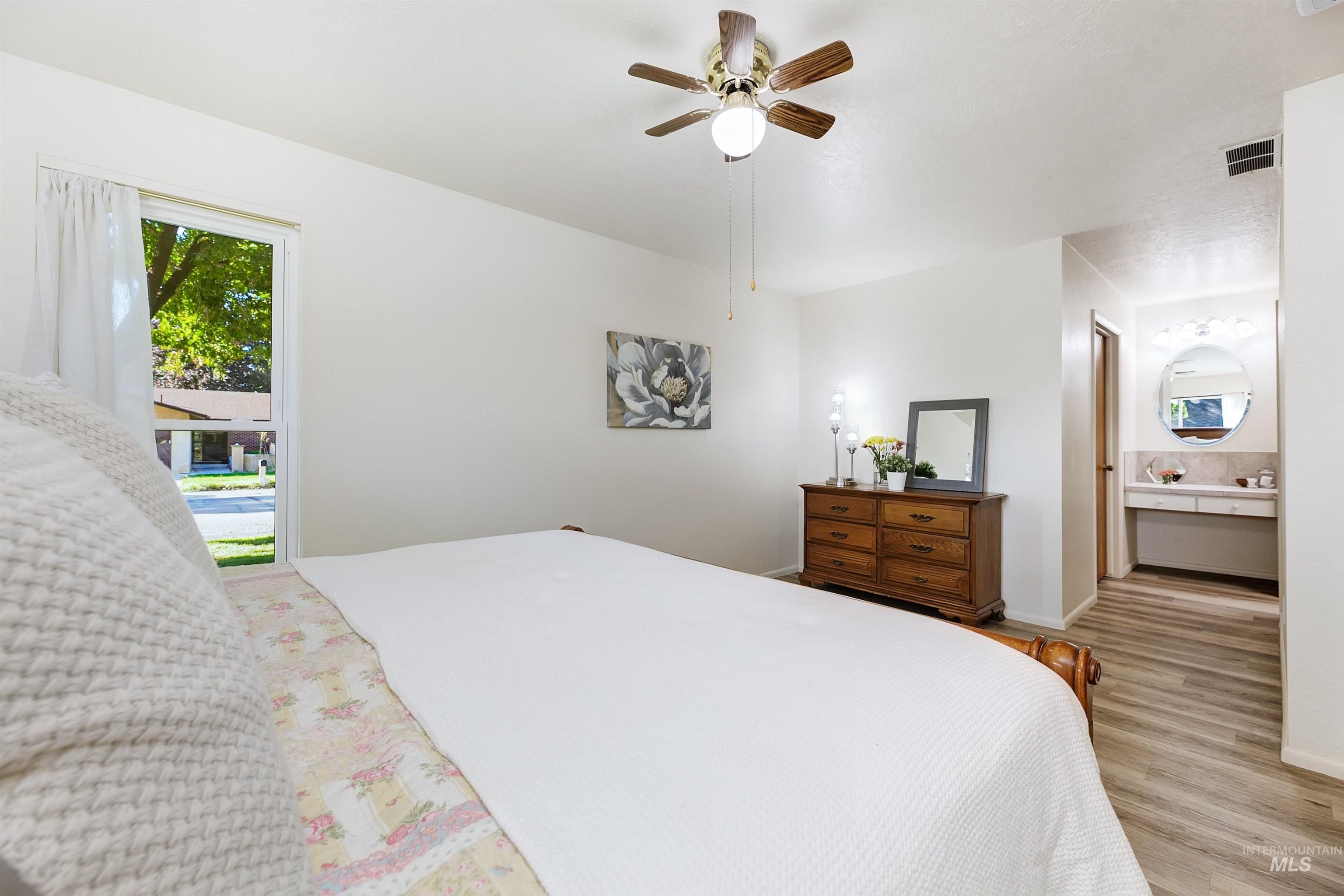Primary bedroom featuring ensuite bathroom and walk-in closet.
