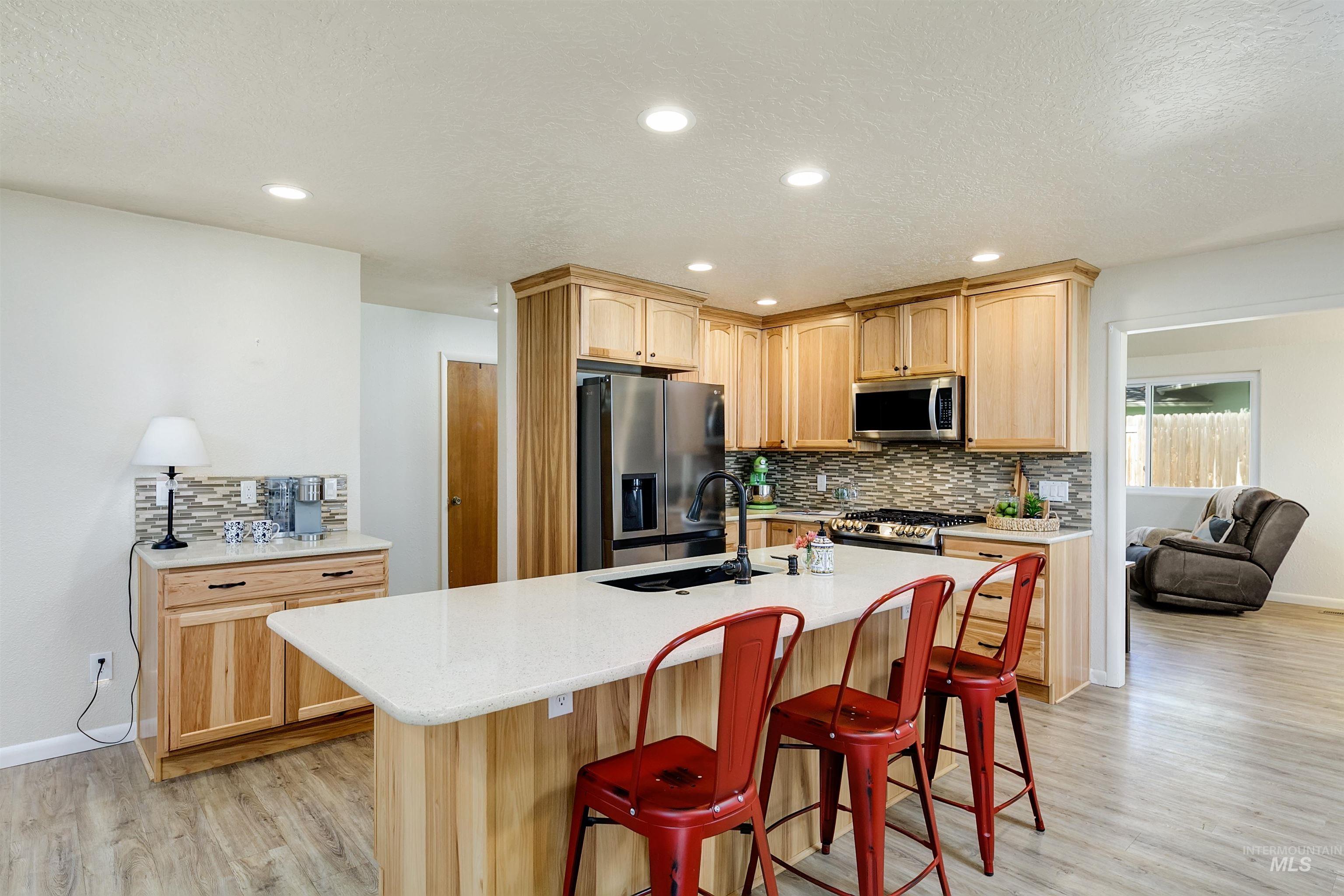 Kitchen with stainless steel finishes and a breakfast bar area.