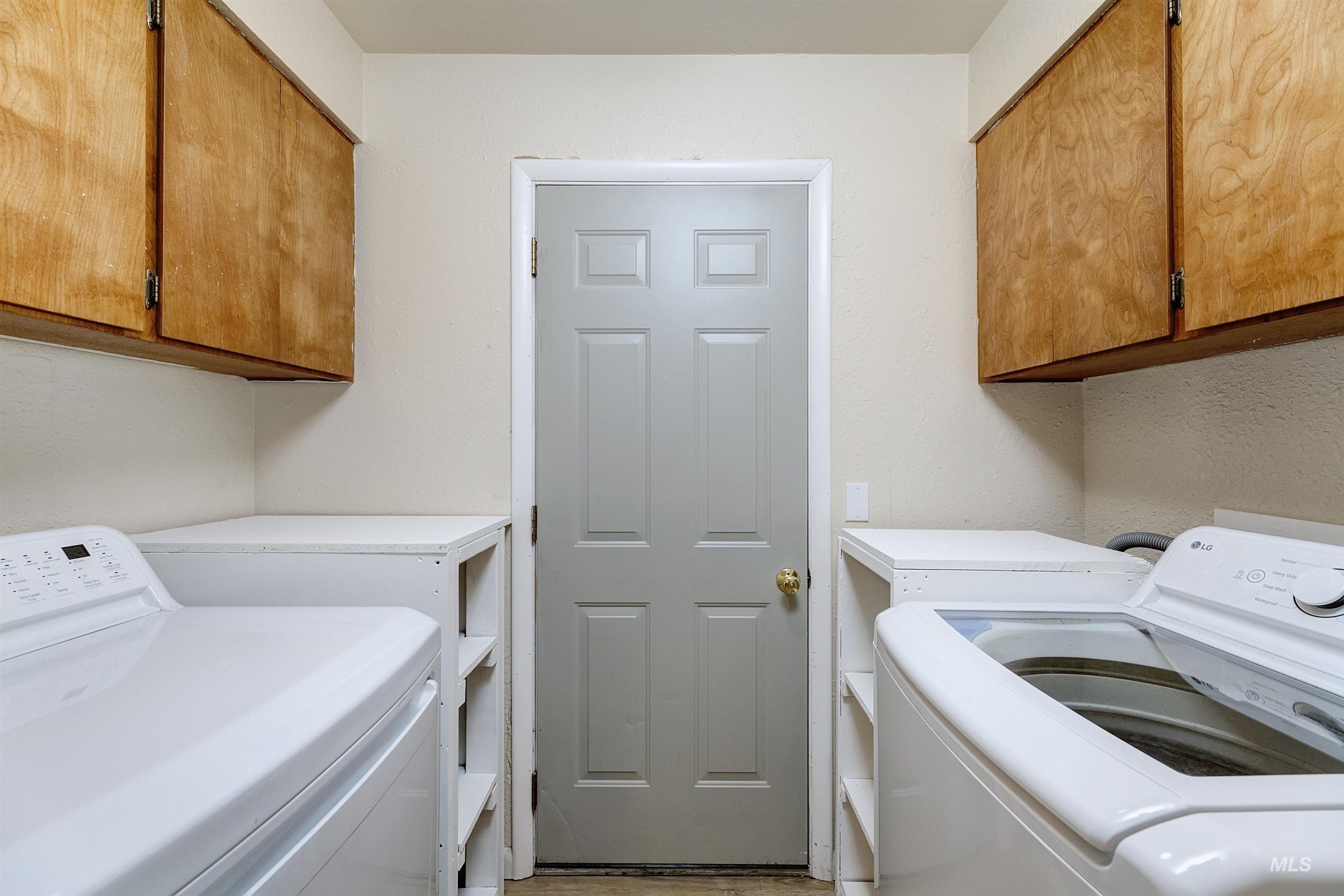 Laundry area with washer and dryer and cabinet space