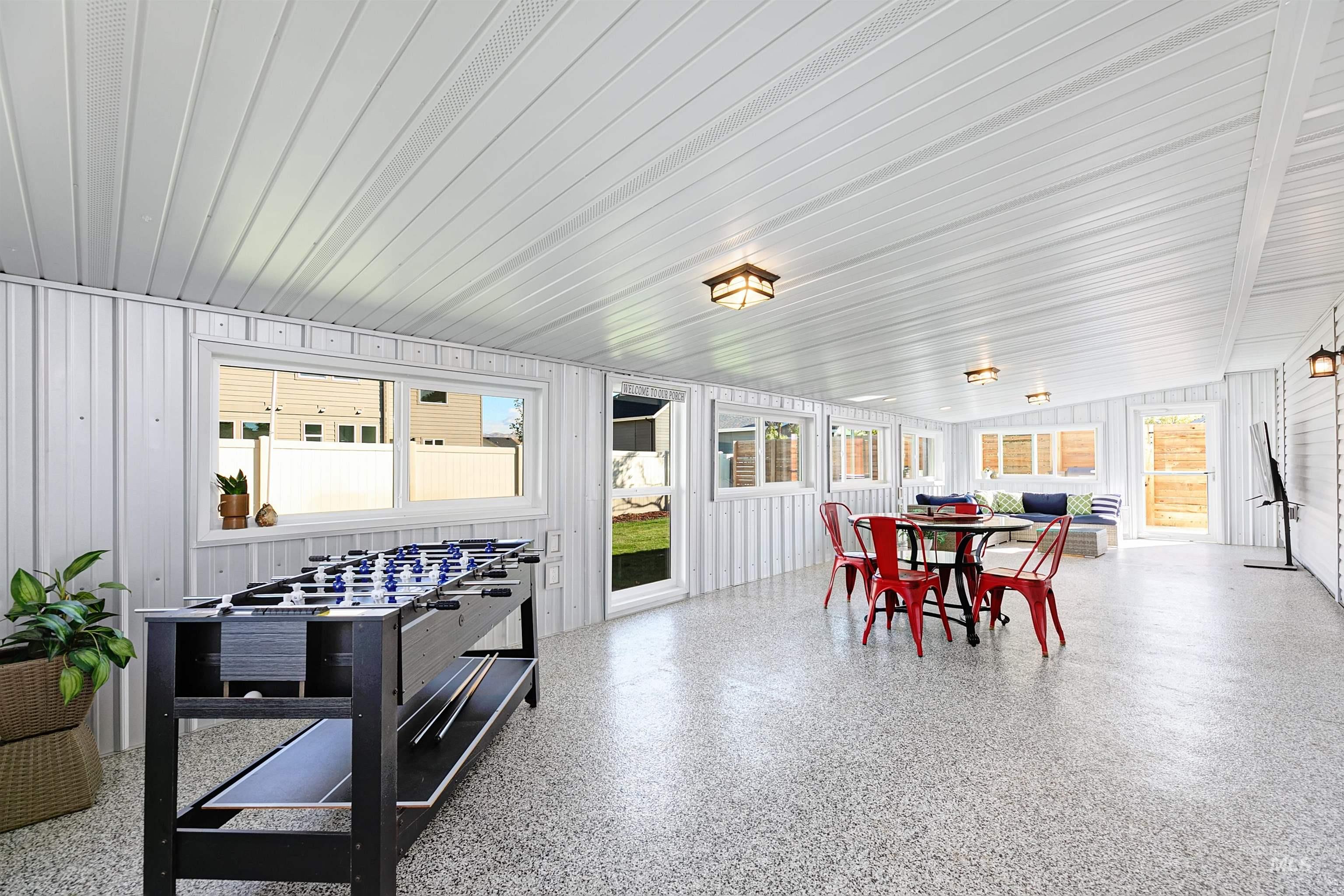 Large sunroom featuring plenty of natural light.