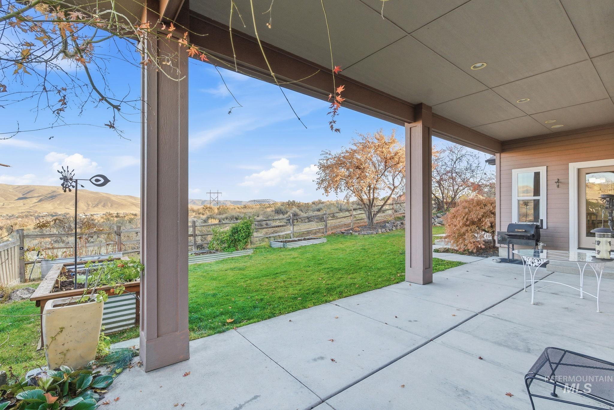 Fenced backyard featuring a covered patio area and a garden
