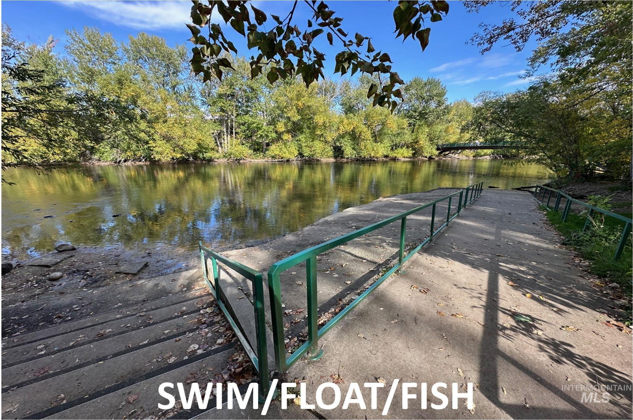 Dock area with a water view and a view of trees