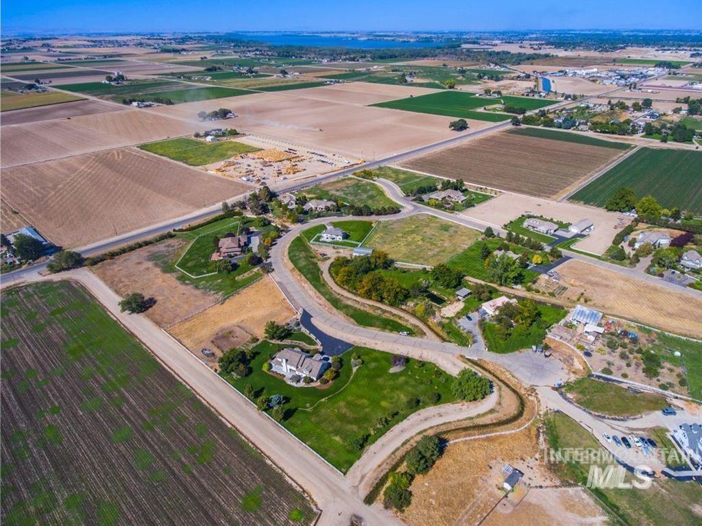 Aerial view of sparsely populated area with large plots for crops