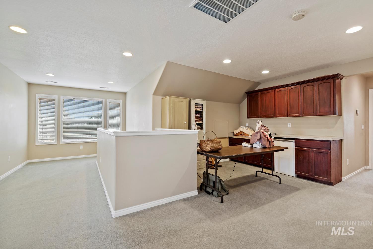 Office featuring light carpet and recessed lighting