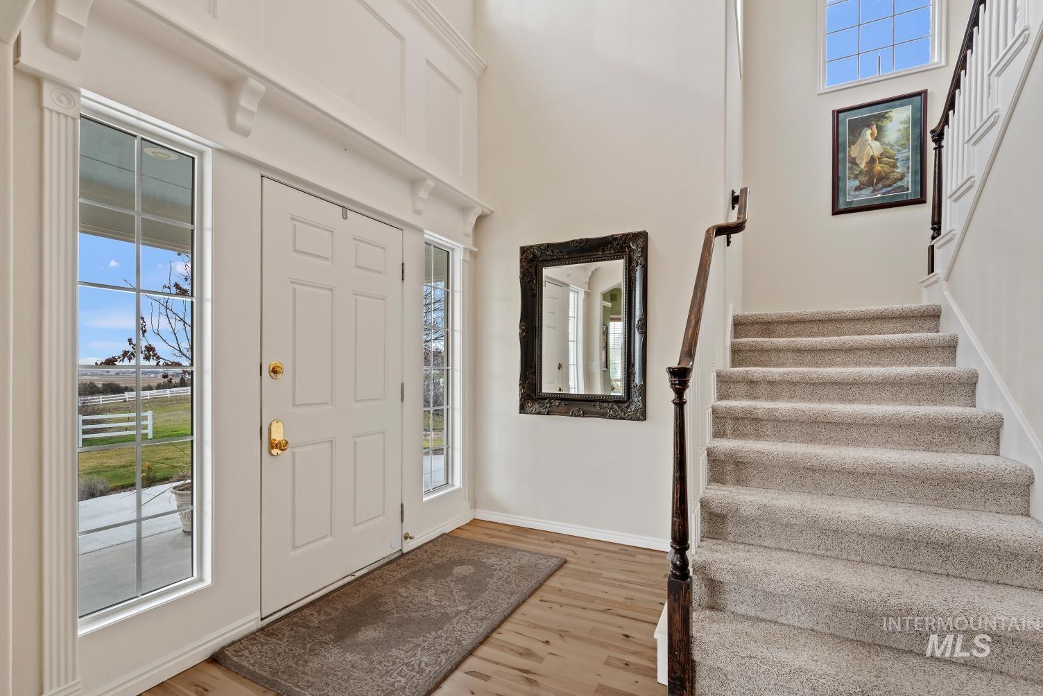 Foyer featuring light wood-style flooring and a high ceiling